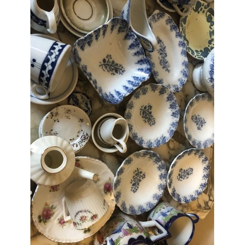49 - A quantity of 19thC + 20thC miniature ceramic and metal pots, pans, plates etc with ceramic animals,... 