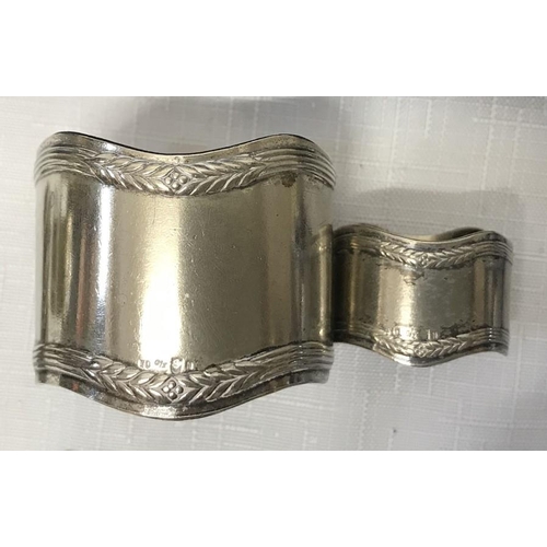 506 - A selection of silver plated napkin rings including a cased set of Parisian souvenir, bracelet, must... 