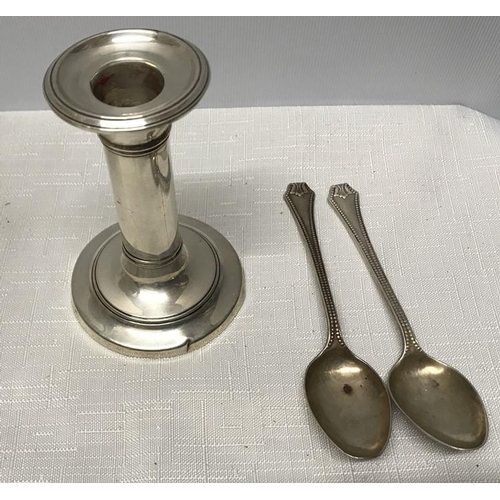 509 - Small silver candlestick and a pair of silver teaspoons, 100gms approx. (no filling to candlestick b... 