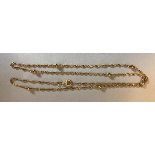 529 - A 9ct yellow gold fine chain and ball necklace. 1.9gms.