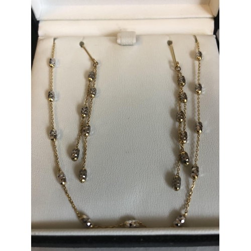 530 - A 9ct gold chain necklace with matching earrings. 3.6gms total.