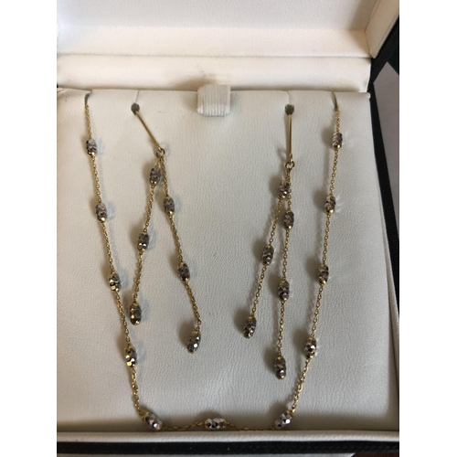 530 - A 9ct gold chain necklace with matching earrings. 3.6gms total.