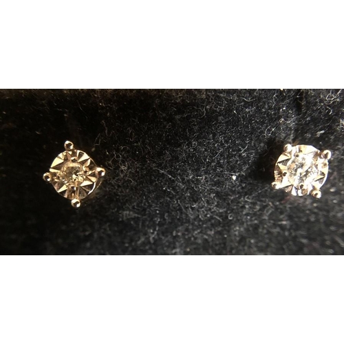 531 - A pair of 9ct white gold and diamond stud earrings.