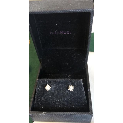 531 - A pair of 9ct white gold and diamond stud earrings.