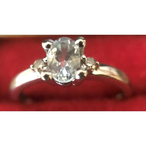 545 - Ladies dress ring set with aquamarine and two diamonds, marked 9ct, size I/J, weight 1.8 gms.