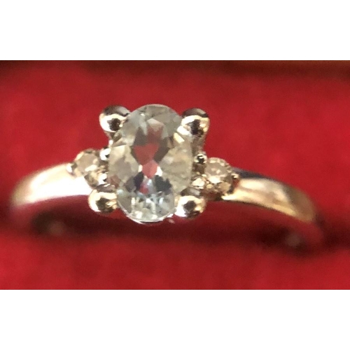 545 - Ladies dress ring set with aquamarine and two diamonds, marked 9ct, size I/J, weight 1.8 gms.