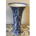 A Chinese moulded porcelain blue & white sleeve vase with all over foliage pattern in moulded panels... 