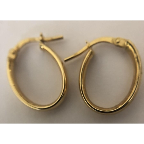 577 - A pair of 9ct yellow gold hoop earrings. 0.9gms.