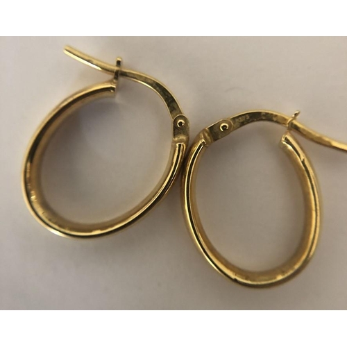 577 - A pair of 9ct yellow gold hoop earrings. 0.9gms.