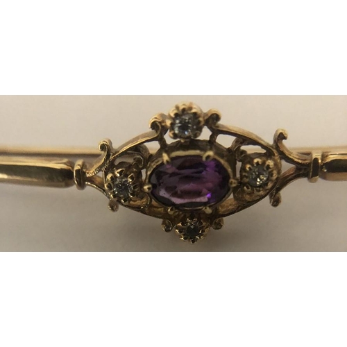 579 - An amethyst and diamond bar brooch in 9ct yellow metal. 2.9gms.