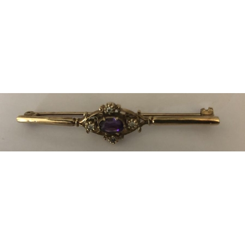 579 - An amethyst and diamond bar brooch in 9ct yellow metal. 2.9gms.