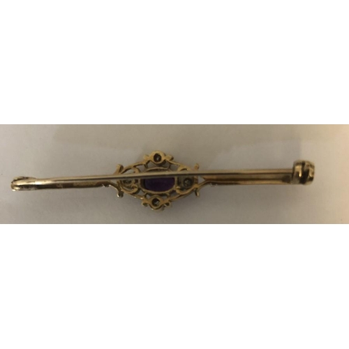 579 - An amethyst and diamond bar brooch in 9ct yellow metal. 2.9gms.