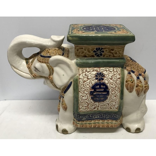 62 - Decorative pottery elephant stool. 38cms h x 52cms l.