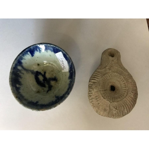 72 - Blue and white ceramic dish 6.5cm d, together with a Roman oil lamp.