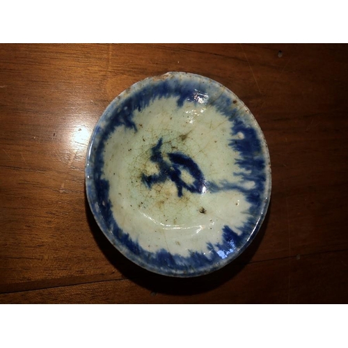 72 - Blue and white ceramic dish 6.5cm d, together with a Roman oil lamp.