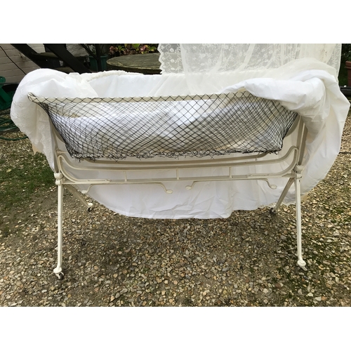 1433A - A late 19th/early 20thC metal swinging crib complete with modern lace drapes. With makers mark photo... 