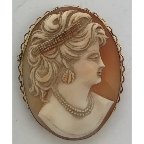 114 - Shell cameo brooch of a female head mounted in 9ct gold, 4.5 x 3.5cms, 11.7gms total weight.