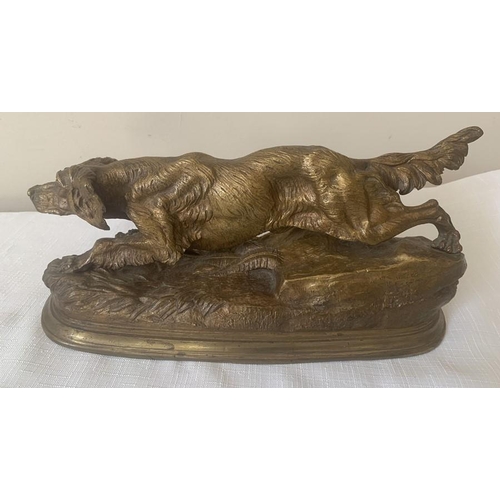 1151 - A bronze animalier figure of a setter dog. 30cms L.