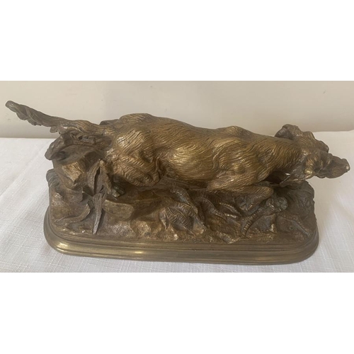 1151 - A bronze animalier figure of a setter dog. 30cms L.