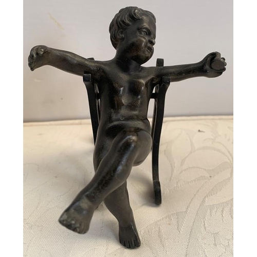 1161 - A 19thC bronze cherub with outstretched arms, on an associated shaped stand. 10cms h.