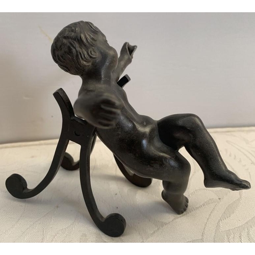 1161 - A 19thC bronze cherub with outstretched arms, on an associated shaped stand. 10cms h.