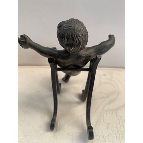 1161 - A 19thC bronze cherub with outstretched arms, on an associated shaped stand. 10cms h.