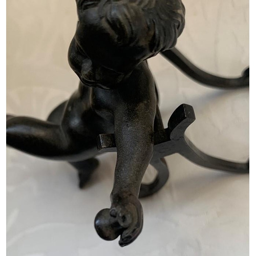 1161 - A 19thC bronze cherub with outstretched arms, on an associated shaped stand. 10cms h.