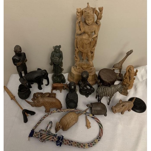 1172 - A large quantity of mostly wooden, ceramic and soapstone figures plus a beadwork whip and skin cover... 