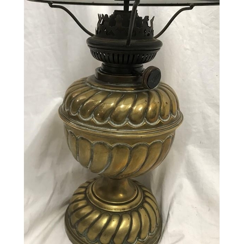 1180 - A Victorian brass oil lamp with milk glass shade, 43cms h with chimney flute.