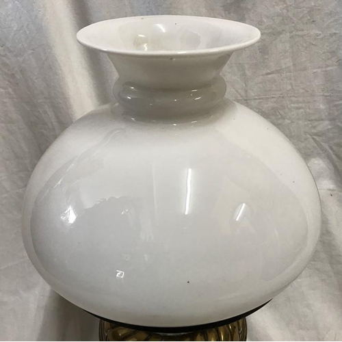 1180 - A Victorian brass oil lamp with milk glass shade, 43cms h with chimney flute.