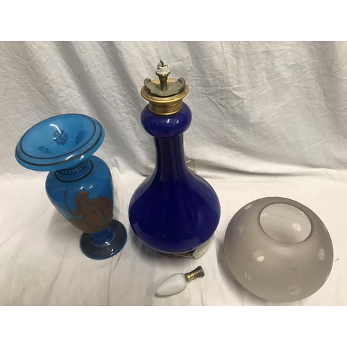 1187 - Blue glass table lamp with frosted engraved globe shade. 57cms h and a blue glass vase with Greek wa... 