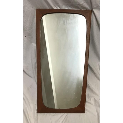 1197 - A 1970's teak framed rectangular wall mirror. 70 h x 31cms w at the bottom, 39cms w at the top.