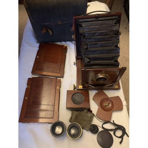 1230 - An early 20thC Reynolds and Branson, Leeds mahogany folding plate camera with two lenses and origina... 