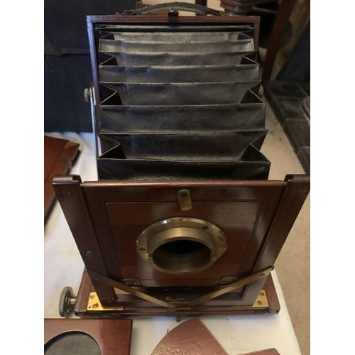 1230 - An early 20thC Reynolds and Branson, Leeds mahogany folding plate camera with two lenses and origina... 