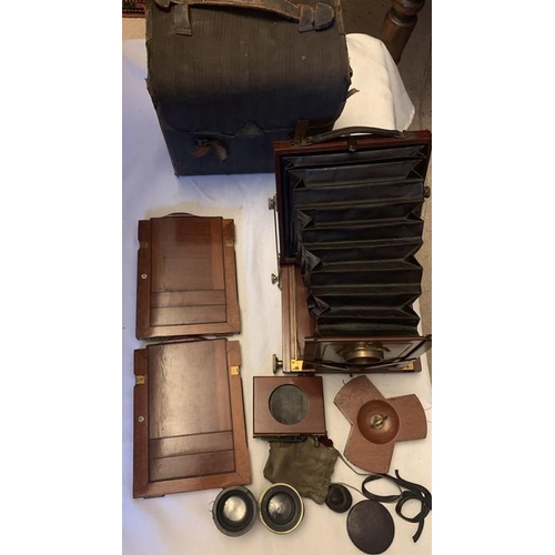 1230 - An early 20thC Reynolds and Branson, Leeds mahogany folding plate camera with two lenses and origina... 