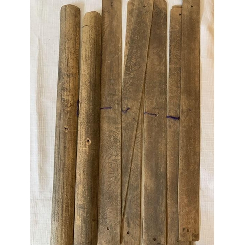 1269 - Two Indonesian scrolls on palm leaves. 43cms l and 41cms l. Intricately drawn pictures to one side o... 