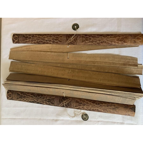 1269 - Two Indonesian scrolls on palm leaves. 43cms l and 41cms l. Intricately drawn pictures to one side o... 