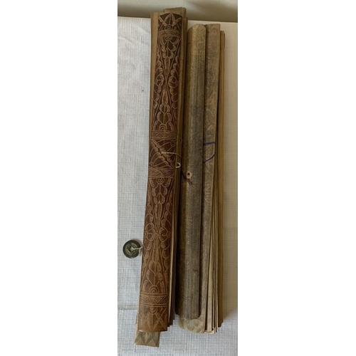 1269 - Two Indonesian scrolls on palm leaves. 43cms l and 41cms l. Intricately drawn pictures to one side o... 