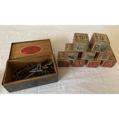 1274 - A vintage metal cigarette box containing various keys and 9 19thC child's building blocks.