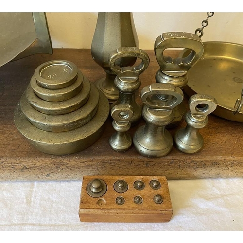 1276 - Set of brass balance scales and weights on mahogany base including 5 bell weights.