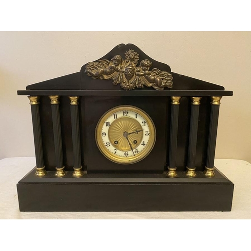 1278 - Black slate mantle clock with 6 Corinthian columns. Sounding on a gong, made in France. 42.5cms w x ... 