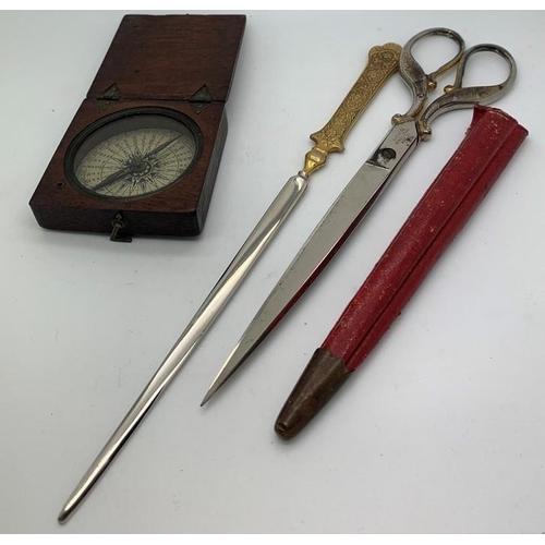 1288 - A mid 19thC boxed compass 6.5 x 6.5cms and scissors on paper knife in red leather case.