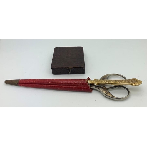 1288 - A mid 19thC boxed compass 6.5 x 6.5cms and scissors on paper knife in red leather case.