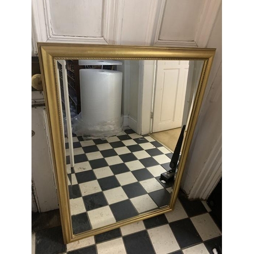 1292 - Modern large gold framed mirror 70 x 101cms with bevelled glass.