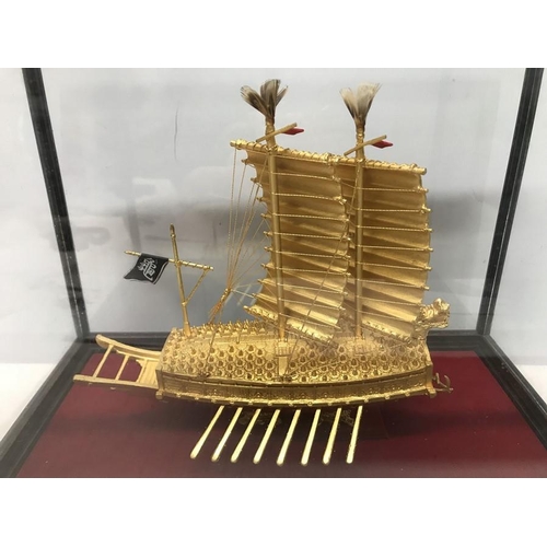 1296 - A 24ct gold plated Korean Turtle ship model in a glazed display case. Case measures 32 w x 19 d x 24... 