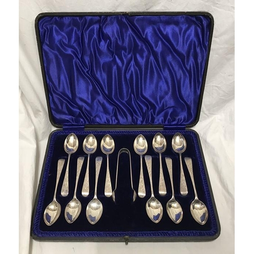 133 - Hallmarked silver cased set of 12 teaspoons plus sugar tongs with engraved handles. J.S. Sheffield 1... 