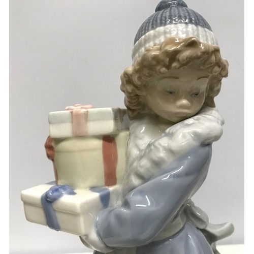 143 - Nao Lladro Daisa 1985, figurine girl with gift boxes, 23cms h.