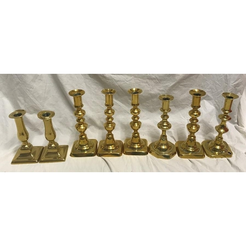 148 - Selection of brass candlesticks. Set of three 20cms h, a pair 15cms h and three singular candlestick... 