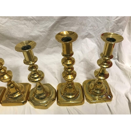 148 - Selection of brass candlesticks. Set of three 20cms h, a pair 15cms h and three singular candlestick... 