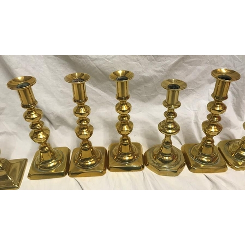 148 - Selection of brass candlesticks. Set of three 20cms h, a pair 15cms h and three singular candlestick... 